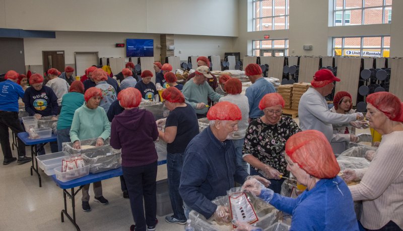 Volunteers are busy filling bags with dehydrated food.